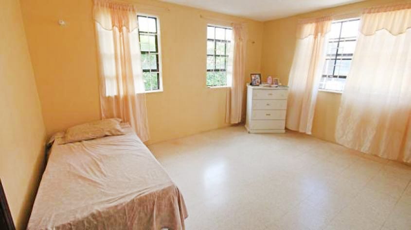 Bedroom off of Foyer single bed ground floor baje curtains