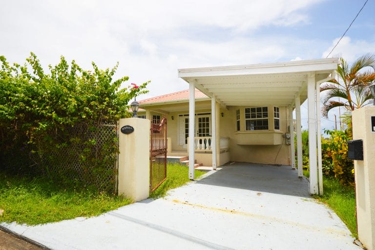 Entrance view of a three bedroom Barbados home for sale with mature tropical gardens in Saint Phillip, Barbados.
